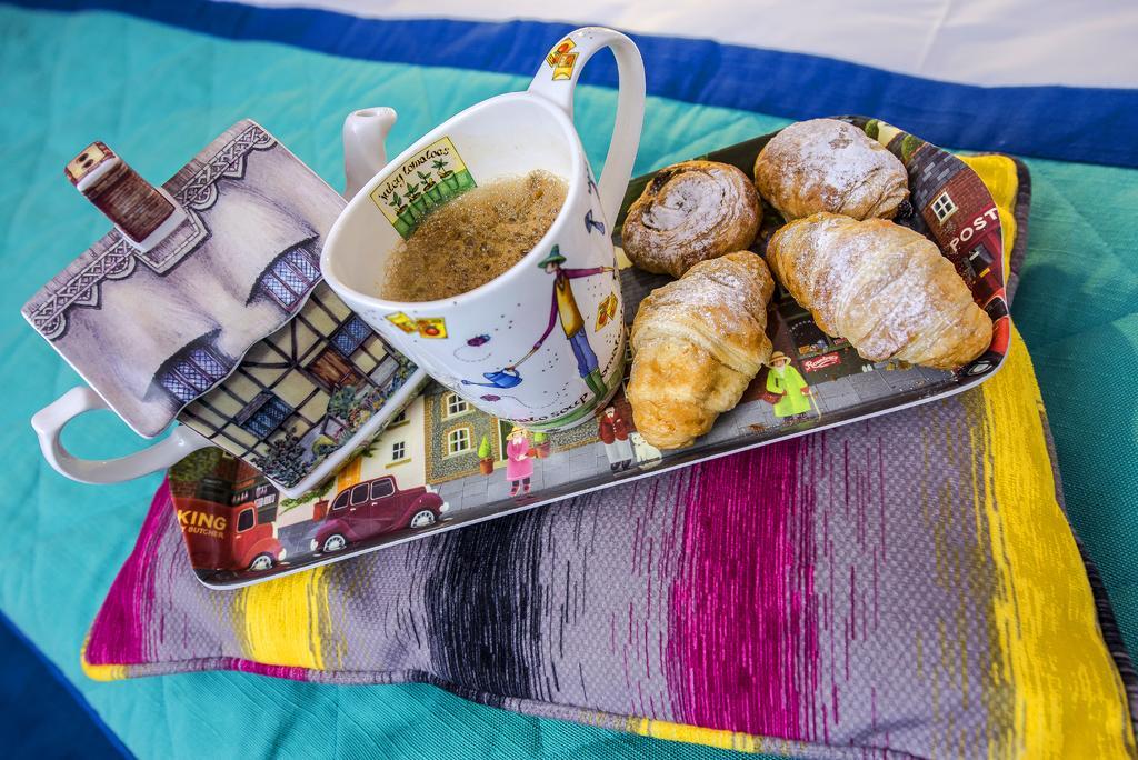 Marshal Garden Hotel Bucharest Exterior photo A cup of tea with a selection of pastries